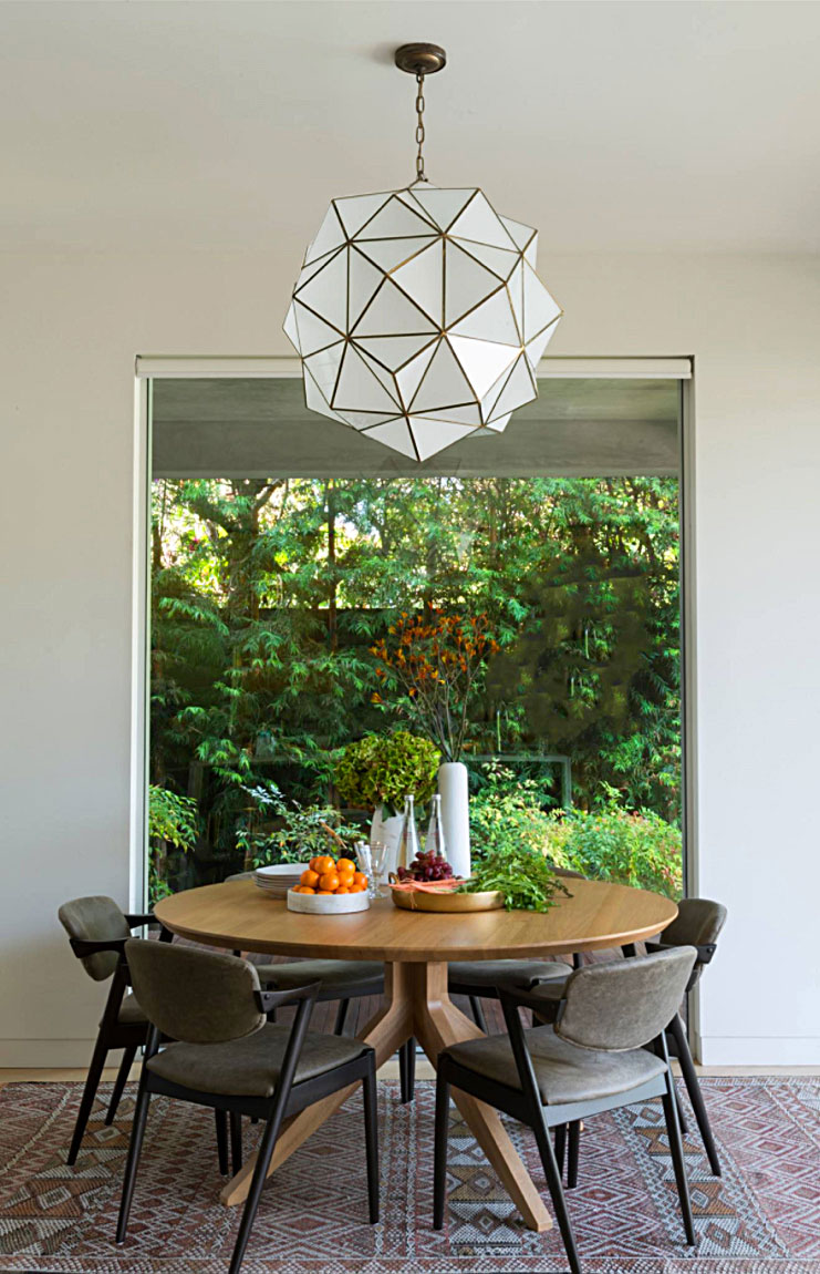 focal point of the dining room, the rombus pendant light fixture from the granada collection. interior design by disc interiors.