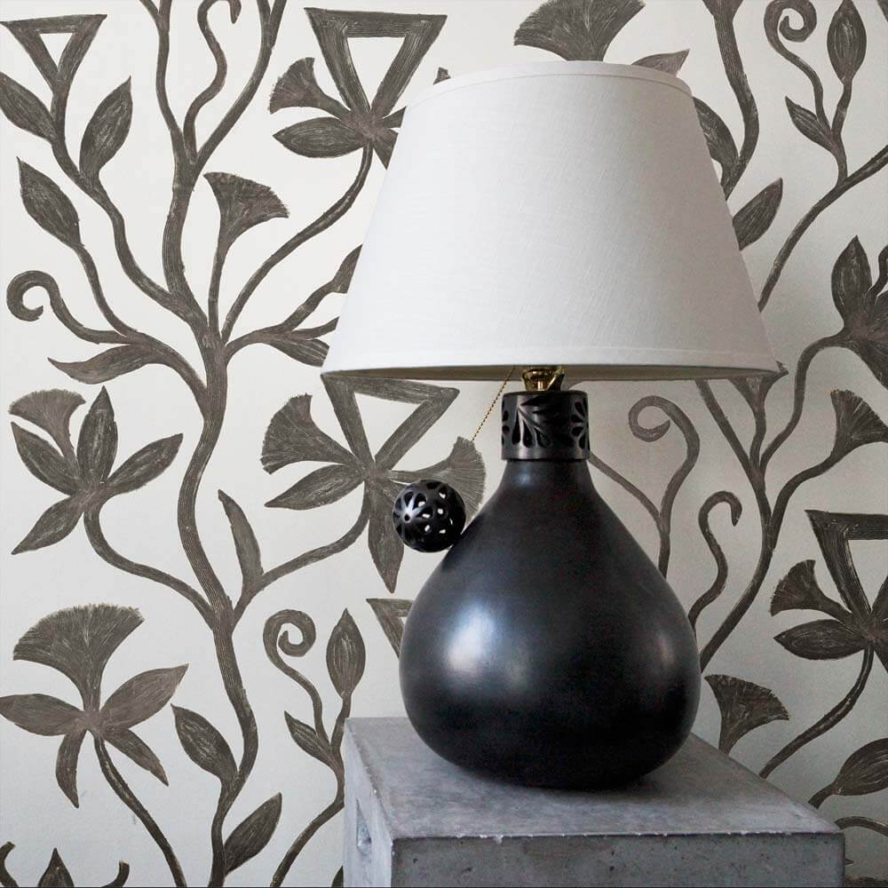 khovar collection, vine wallpaper featured with a black ceramic barro negro table lamp.