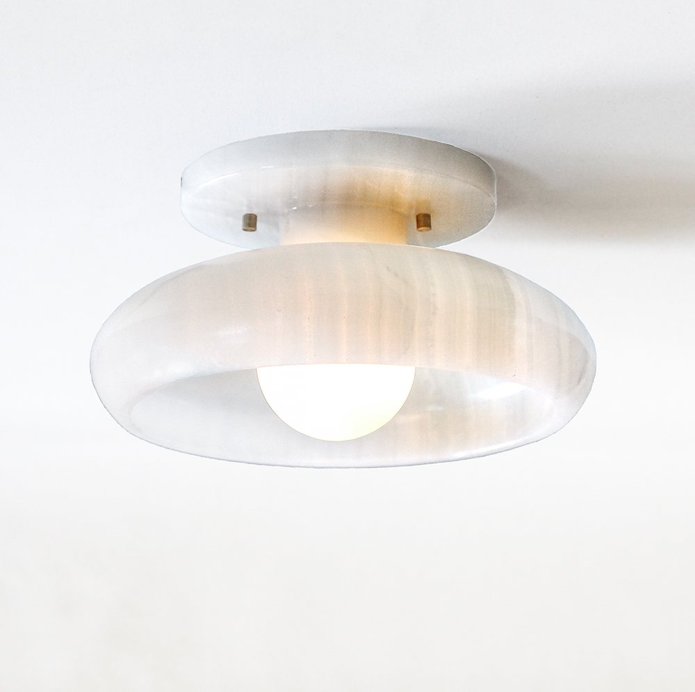 lit modern stone ceiling semi-flush mount light fixture in milk white onyx and a tala bulb.
