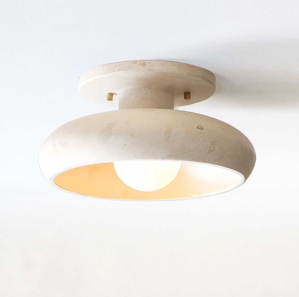 lit modern stone ceiling semi-flush mount light fixture in travertine marble and a tala bulb.