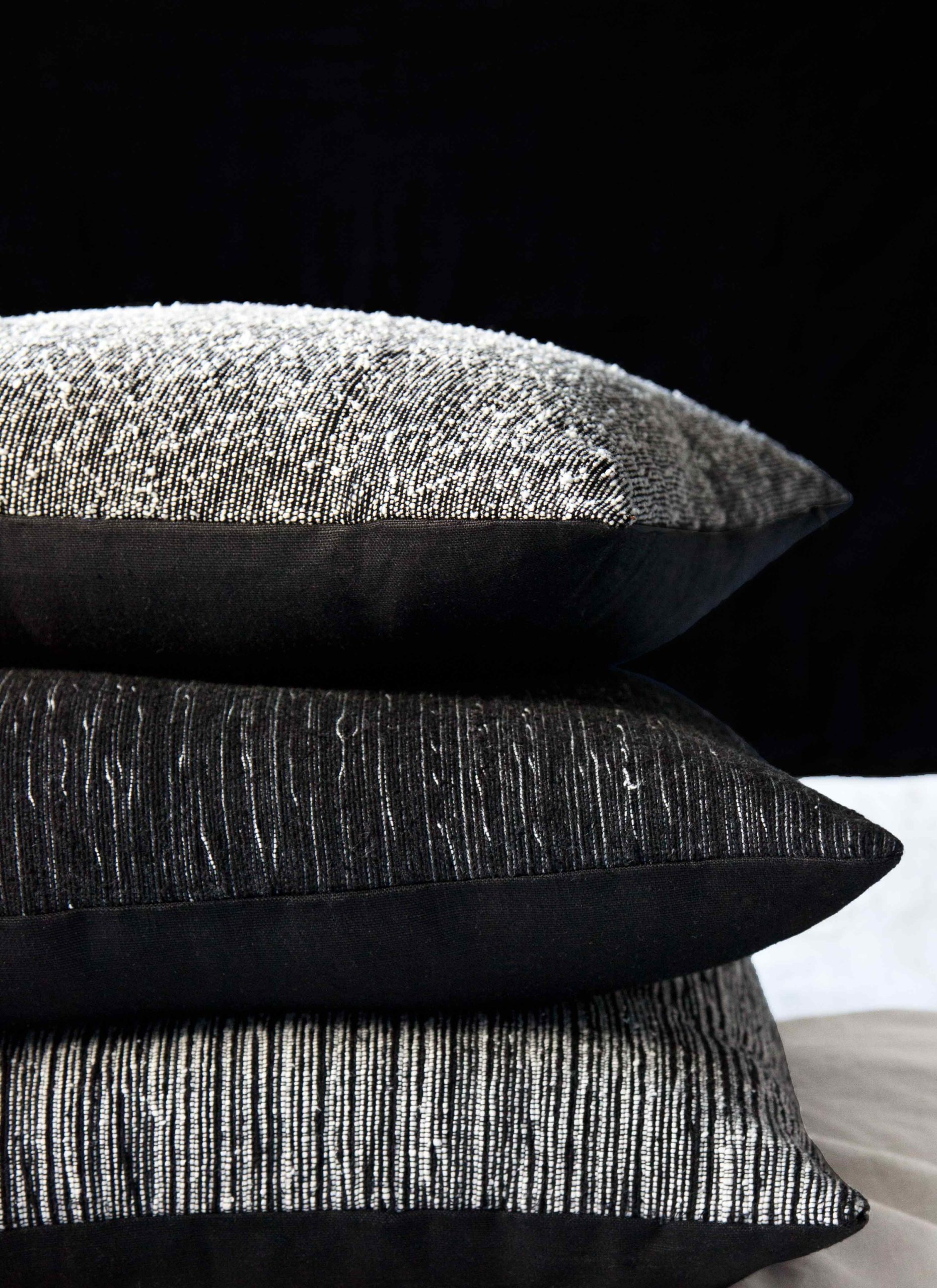 djellaba decorative throw pillows in textured wool and cotton. wool boucle and cotton patterned striations.