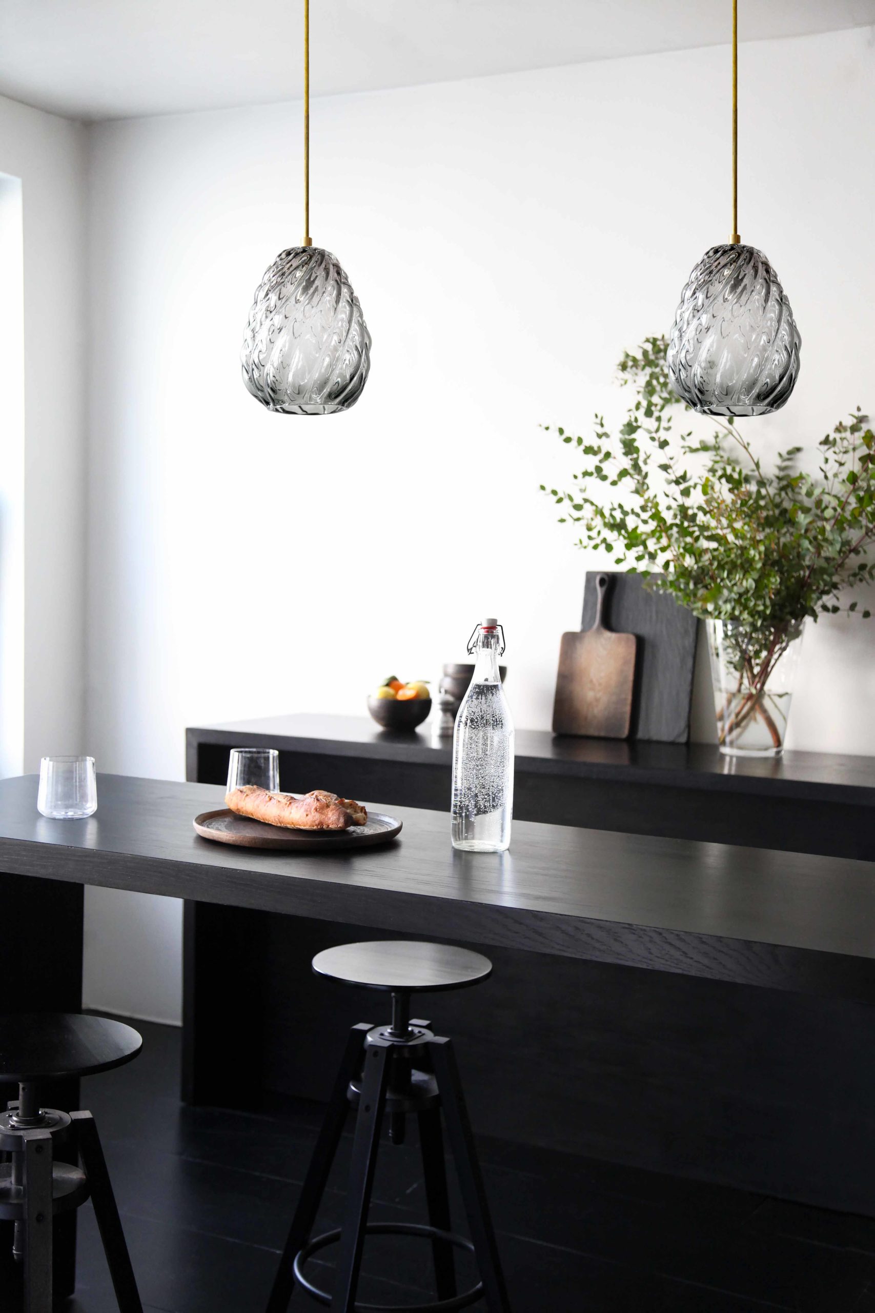 glass pendant lights over modern kitchen island counter.