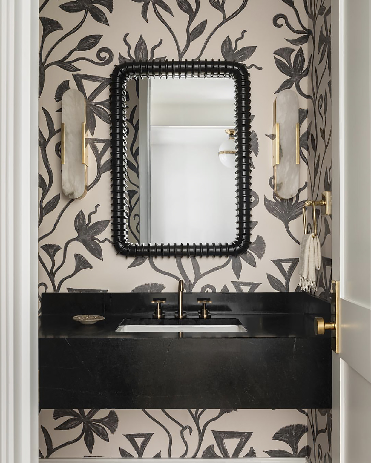 graphic, khovar wallpaper in a powder room designed by Brian Paquette Interiors.